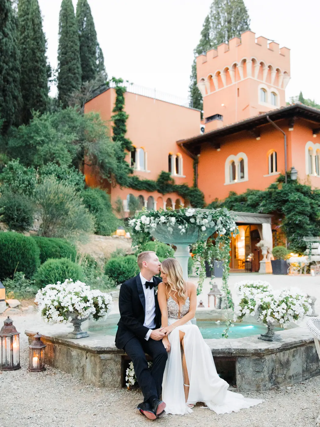Intimate moment between the newlyweds captured in the courtyard of a Tuscan villa, surrounded by the romance of Italy's medieval history.
