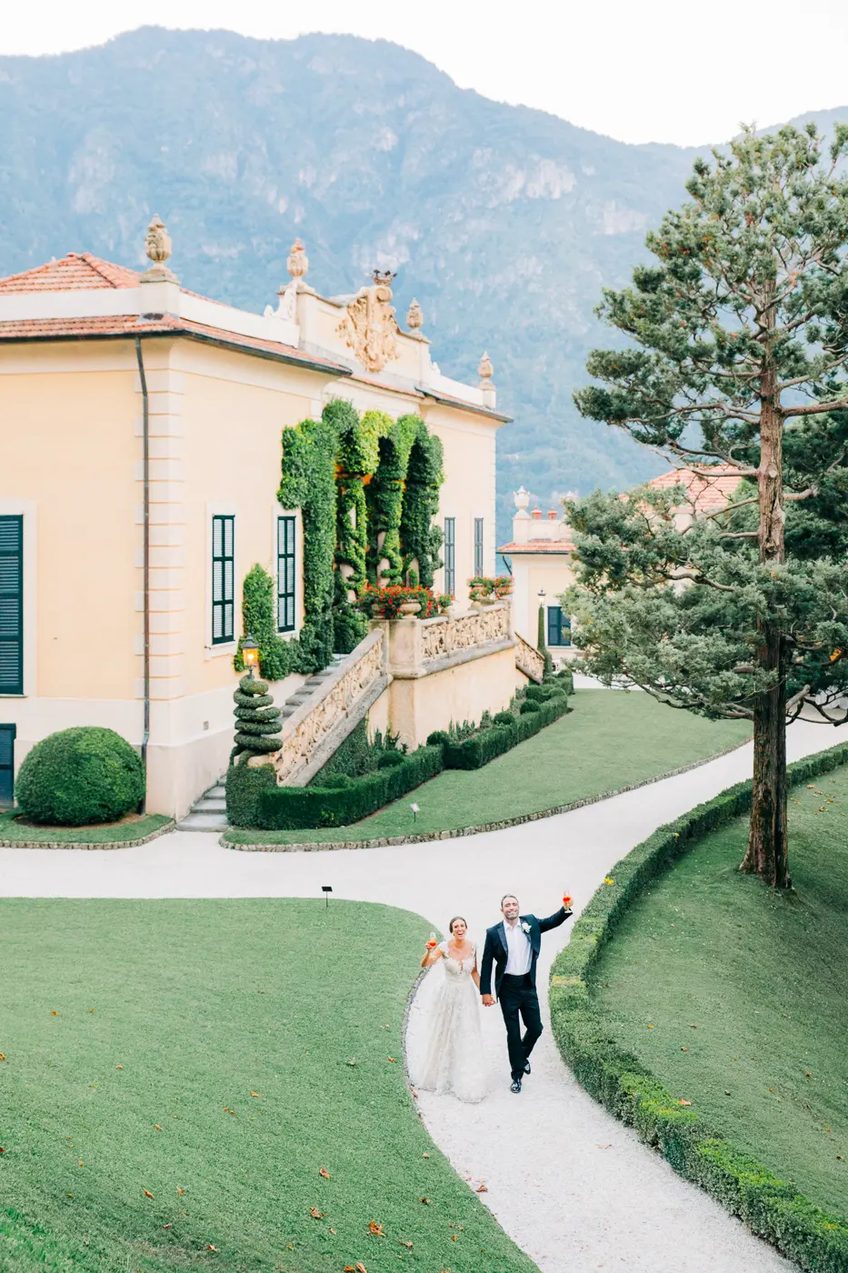 Bride and groom walking on the Villa del Balbianello