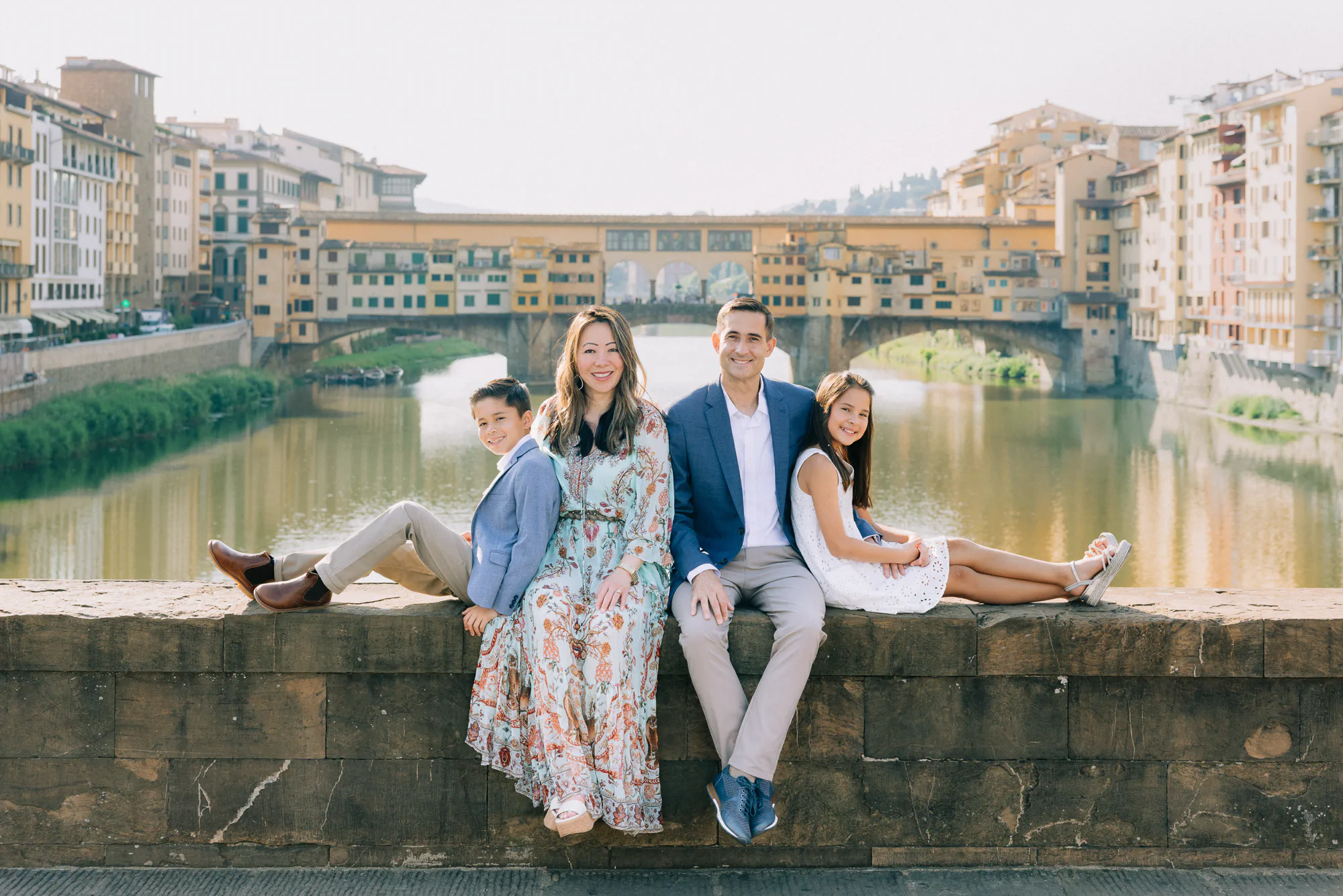 Family of four portrait by the Ponte Vecchio view during their Florence vacation